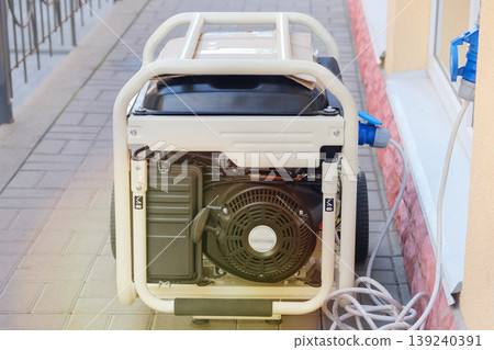 Energy independence in business. Use mobile generator. Diesel power generator. Outdoor power supply generator placed on street sidewalk. Sunny day. 139240391
