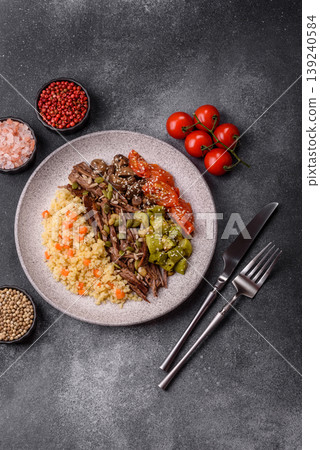 A bowl with beef, porridge, mushrooms, vegetables, sauce, and spices. Beef bowl A bowl with beef, porridge, mushrooms, vegetables, sauce, and spices. Beef bowl 139240584