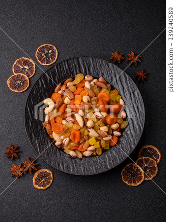 A mix of nuts and dried fruits as ingredients for a healthy meal. Nuts and dried fruits A mix of nuts and dried fruits as ingredients for a healthy meal. Nuts and dried fruits 139240589