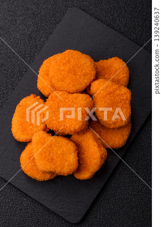 Fried chicken nuggets with sauce, salt, and spices, fast food, unhealthy food. Chicken nuggets Fried chicken nuggets with sauce, salt, and spices, fast food, unhealthy food. Chicken nuggets 139240637
