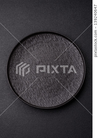 An empty ceramic round plate, kitchen utensils for a dinner table. An empty plate An empty ceramic round plate, kitchen utensils for a dinner table. An empty plate 139240647