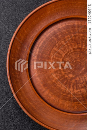 An empty ceramic round plate, kitchen utensils for a dinner table. An empty plate An empty ceramic round plate, kitchen utensils for a dinner table. An empty plate 139240648