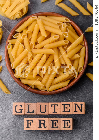 Italian uncooked, dry, gluten free penne pasta, ready for cooking. Dry, gluten free penne pasta Italian uncooked, dry, gluten free penne pasta, ready for cooking. Dry, gluten free penne pasta 139240664