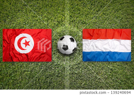 Tunisia vs. Netherlands flags on a soccer field 139240694