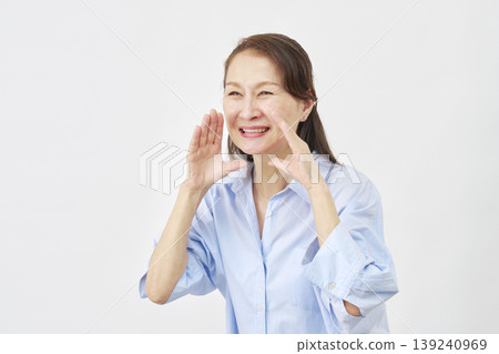 A woman calling out against a white background, facing left. A woman calling out against a white background, facing left. 139240969
