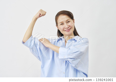 Elderly woman doing bicep pose on white background Elderly woman doing bicep pose on white background 139241001