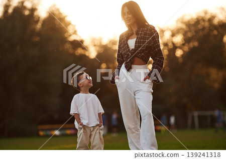 Mother and son together in an open field during daytime 139241318