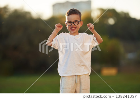 Boy is having fun on the field under sunlight at daytime Boy is having fun on the field under sunlight at daytime 139241357