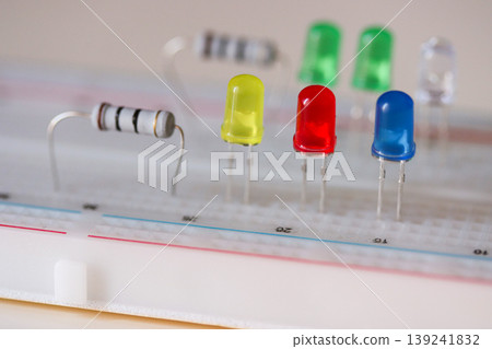 Electronics prototyping with LEDs and resistor on breadboard, close-up circuit components Electronics prototyping with LEDs and resistor on breadboard, close-up circuit components 139241832