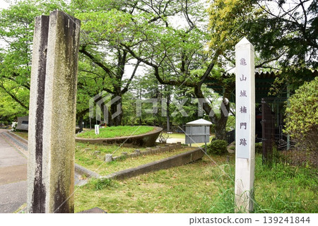 Mie Prefecture: Stone pillars at the site of the Kusunoki Gate of Kameyama Castle, Kameyama Park, and fresh greenery. 139241844
