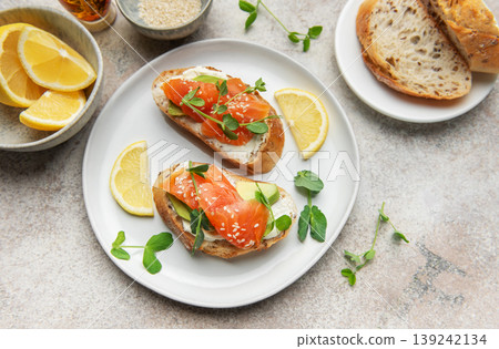 Salmon bruschetta with cream cheese and avocado slices 139242134