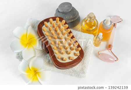 Spa wellness treatment with massage oil and stones 139242139
