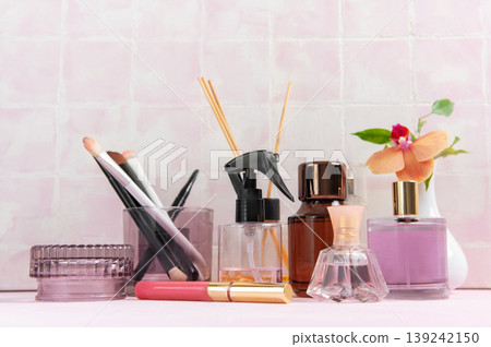 Beauty products and perfume bottles on pink background Beauty products and perfume bottles on pink background 139242150
