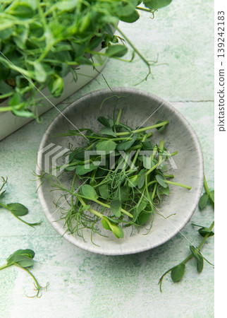 Harvesting fresh pea shoots in a bowl 139242183