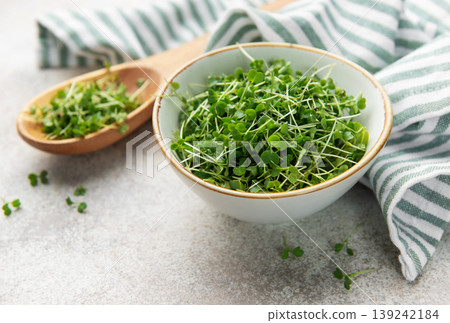 Fresh microgreens in bowl and wooden spoon Fresh microgreens in bowl and wooden spoon 139242184