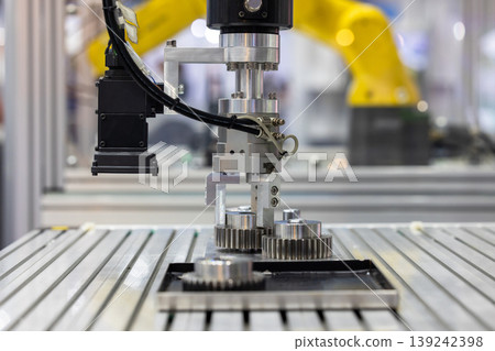 Industrial robotic arm with machine vision camera picking metal gears in automated factory line, Robotic gripper handling steel machine, Automated robotic system smart factory. Industrial robotic arm with machine vision camera picking metal gears in automated factory line, Robotic gripper handling steel machine, Automated robotic system smart factory. 139242398