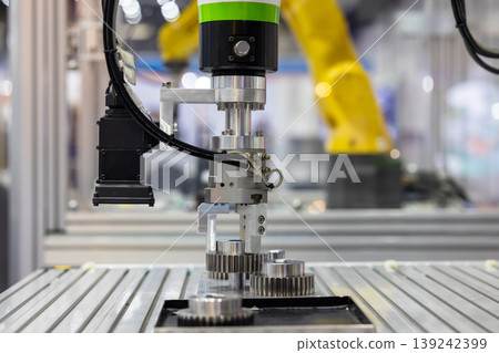 Industrial robotic arm with machine vision camera picking metal gears in automated factory line, Robotic gripper handling steel machine, Automated robotic system smart factory. Industrial robotic arm with machine vision camera picking metal gears in automated factory line, Robotic gripper handling steel machine, Automated robotic system smart factory. 139242399