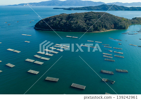 Drone footage of oyster rafts and oyster farming scenes floating in the sea off Ushimado, Okayama Prefecture. Drone footage of oyster rafts and oyster farming scenes floating in the sea off Ushimado, Okayama Prefecture. 139242961
