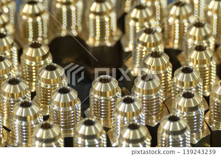 Group of precision brass fitting parts during mass production process by CNC turning machine. Group of precision brass fitting parts during mass production process by CNC turning machine. 139243239