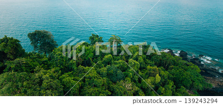 Drone shot of a secluded sandy beach meeting dense tropical rainforest. Drone shot of a secluded sandy beach meeting dense tropical rainforest. 139243294