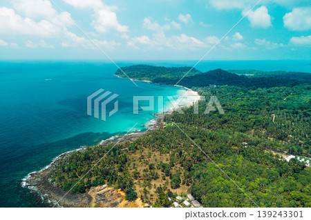 Bright midday sunlight reflecting on clear blue coastal waters and beach. Bright midday sunlight reflecting on clear blue coastal waters and beach. 139243301