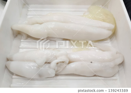 Fresh Raw Cuttlefish Roe and Sperm Sacs in a White Tray for Sushi Preparation Fresh Raw Cuttlefish Roe and Sperm Sacs in a White Tray for Sushi Preparation 139243389
