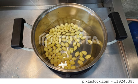 Peeled Yellow Ginkgo Nuts Being Boiled in a Stainless Steel Pot for Cooking Peeled Yellow Ginkgo Nuts Being Boiled in a Stainless Steel Pot for Cooking 139243395