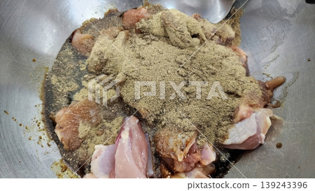 Raw Chicken Breast Pieces Seasoned with Ground Spices and Marinade in a Metal Bowl Raw Chicken Breast Pieces Seasoned with Ground Spices and Marinade in a Metal Bowl 139243396
