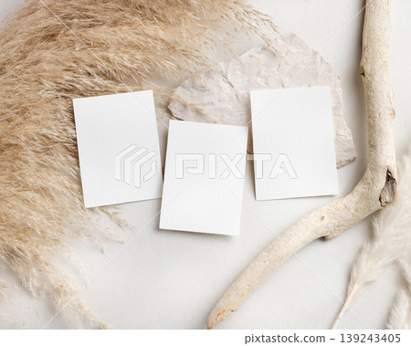 Blank wedding cards suite mockup with pampas grass on beige stone top view, boho wedding stationery 139243405