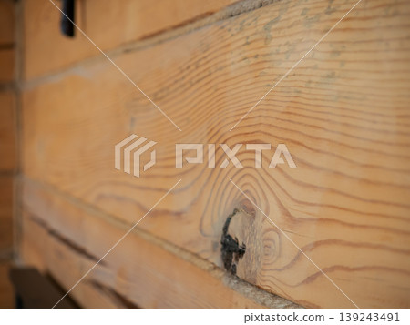 Brown pine wood plank with natural grain and knot texture. Rustic timber wall background for interior design project. Organic building material for construction and home decoration. 139243491