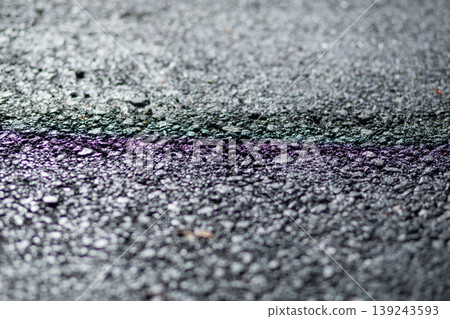 Dark wet asphalt road surface with abstract rainbow oil reflection. Texture of coarse pavement with raindrop after heavy rain. Background for urban city street or transportation concept. Dark wet asphalt road surface with abstract rainbow oil reflection. Texture of coarse pavement with raindrop after heavy rain. Background for urban city street or transportation concept. 139243593
