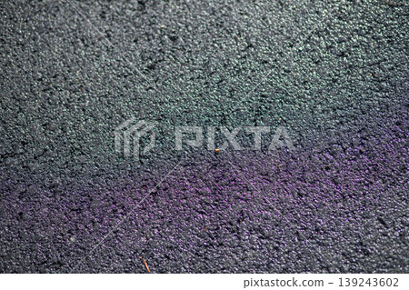 Dark wet asphalt road surface with abstract rainbow oil reflection. Texture of coarse pavement with raindrop after heavy rain. Background for urban city street or transportation concept. Dark wet asphalt road surface with abstract rainbow oil reflection. Texture of coarse pavement with raindrop after heavy rain. Background for urban city street or transportation concept. 139243602