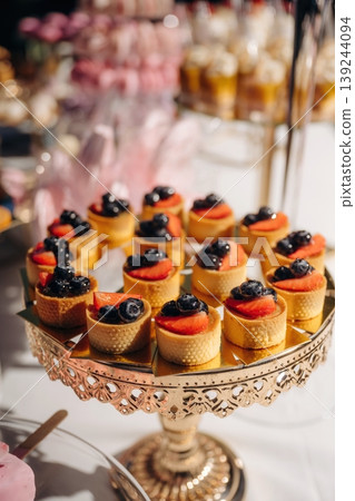 Bilberry on top. Close up view of rounded sweets on the table, delicious food Bilberry on top. Close up view of rounded sweets on the table, delicious food 139244094