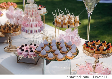 Served for the event. Party table with lot of sweets, desserts. Conception of celebration Served for the event. Party table with lot of sweets, desserts. Conception of celebration 139244119
