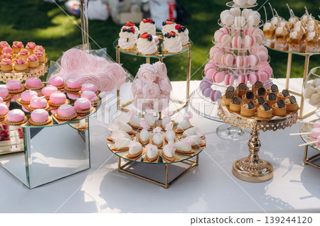 Served for the event. Party table with lot of sweets, desserts. Conception of celebration Served for the event. Party table with lot of sweets, desserts. Conception of celebration 139244120