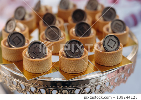 Chocolate pieces on top. Detailed close up view of bunch of delicious sweets, celebration event 139244123
