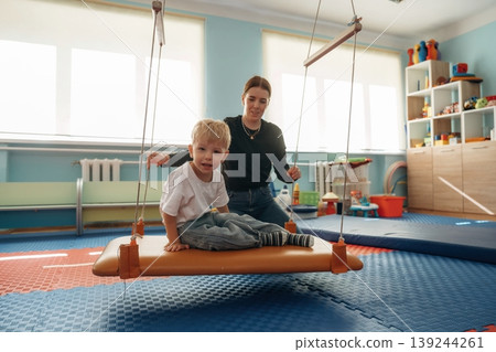 Preschool child with teacher during developmental activities in a playroom 139244261