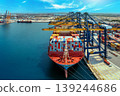 Aerial view of cargo ship and cargo container in harbor. 139244686