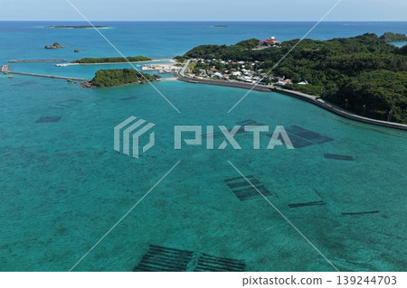 Drone aerial photography of a coastal village and mozuku seaweed farm on Hamahiga Island, Okinawa Prefecture. Drone aerial photography of a coastal village and mozuku seaweed farm on Hamahiga Island, Okinawa Prefecture. 139244703
