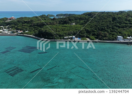 Drone aerial photography of a coastal village and mozuku seaweed farm on Hamahiga Island, Okinawa Prefecture. Drone aerial photography of a coastal village and mozuku seaweed farm on Hamahiga Island, Okinawa Prefecture. 139244704