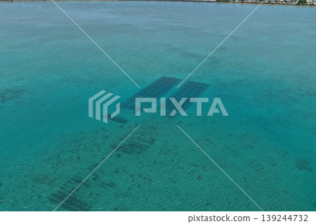 Drone aerial footage of mozuku seaweed farms and the clear waters around Hamahiga Island, Okinawa Prefecture. Drone aerial footage of mozuku seaweed farms and the clear waters around Hamahiga Island, Okinawa Prefecture. 139244732