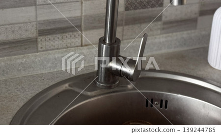 Modern Kitchen Faucet with Sleek Design and Stainless Steel Finish Modern Kitchen Faucet with Sleek Design and Stainless Steel Finish 139244785