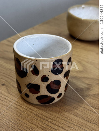 Stylish Leopard Print Ceramic Mug on Wooden Table Stylish Leopard Print Ceramic Mug on Wooden Table 139244855