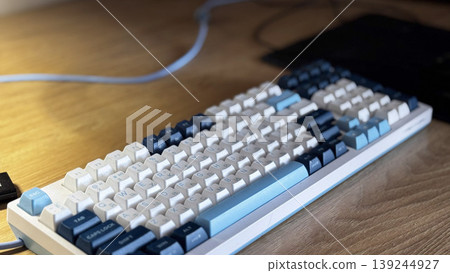Stylish Mechanical Keyboard on Wooden Desk for Gaming and Typing Stylish Mechanical Keyboard on Wooden Desk for Gaming and Typing 139244927