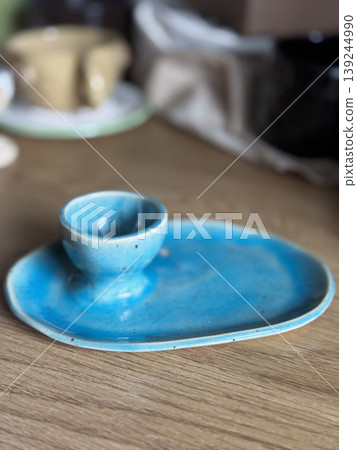 Beautiful Blue Ceramic Dish with Cup on Wooden Table 139244990