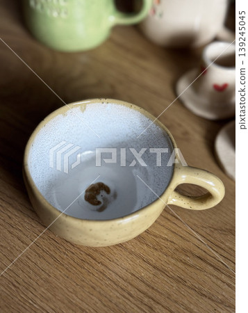 Rustic Yellow Coffee Cup on Wooden Table 139245045