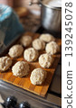 Homemade Dough Balls on a Wooden Cutting Board in a Cozy Kitchen 139245078