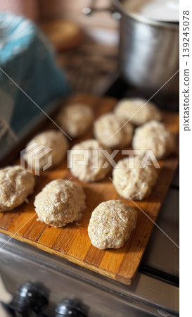 Homemade Dough Balls on a Wooden Cutting Board in a Cozy Kitchen Homemade Dough Balls on a Wooden Cutting Board in a Cozy Kitchen 139245078