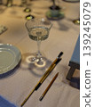 Elegant Table Setting with Glass and Writing Tools 139245079