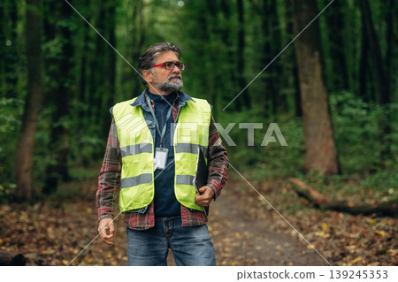 Senior forest ecologist is working in the woods. In the uniform Senior forest ecologist is working in the woods. In the uniform 139245353